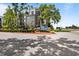 A view of this building's exterior with lush landscaping and a Fox Chase community sign at 3350 Fox Hunt Dr, Palm Harbor, FL 34683