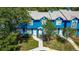 Charming blue townhome with a well-manicured lawn and a welcoming walkway to the front door at 3350 Fox Hunt Dr, Palm Harbor, FL 34683