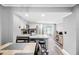 Modern kitchen with granite countertops and stainless steel appliances, open to dining area at 3350 Fox Hunt Dr, Palm Harbor, FL 34683