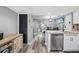 Well-lit kitchen with stainless steel appliances and gray wood flooring at 3350 Fox Hunt Dr, Palm Harbor, FL 34683