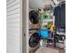 Laundry room with stacked washer and dryer, plus storage shelves at 3350 Fox Hunt Dr, Palm Harbor, FL 34683