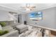 Comfortable living room featuring contemporary decor, a stylish ceiling fan, and large TV at 3350 Fox Hunt Dr, Palm Harbor, FL 34683