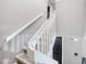 Staircase with wood steps and white railing at 3350 Fox Hunt Dr, Palm Harbor, FL 34683