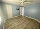 This bedroom features wood flooring, a ceiling fan, and two doors at 34645 Camphor N Dr, Pinellas Park, FL 33781