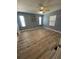 Bedroom featuring three windows and light-colored vinyl flooring at 34645 Camphor N Dr, Pinellas Park, FL 33781