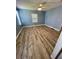 This bedroom features wood flooring, a ceiling fan, and paint on the walls at 34645 Camphor N Dr, Pinellas Park, FL 33781