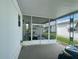 Covered carport area with a screened in porch and a golf cart inside at 34645 Camphor N Dr, Pinellas Park, FL 33781