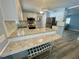 Bright kitchen featuring granite countertops, modern appliances, and wood-look flooring at 34645 Camphor N Dr, Pinellas Park, FL 33781