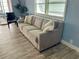Cozy living room showcasing a plush sofa, natural light, and stylish decor at 34645 Camphor N Dr, Pinellas Park, FL 33781