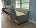 Living room featuring a neutral-toned sleeper sofa and bright natural light at 34645 Camphor N Dr, Pinellas Park, FL 33781