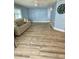 Open-concept living room featuring blue walls and light-colored vinyl flooring at 34645 Camphor N Dr, Pinellas Park, FL 33781