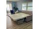Open living room showing a sleeper sofa extended into a bed at 34645 Camphor N Dr, Pinellas Park, FL 33781