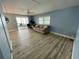 Open-concept living room with a comfortable couch and sliding doors to the patio at 34645 Camphor N Dr, Pinellas Park, FL 33781