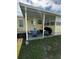 Cozy covered patio with an outdoor dining set, creating the perfect space for al fresco meals and relaxing at 35020 Colony Hills Dr, Zephyrhills, FL 33541