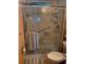 Bathroom featuring safety bars, a glass shower enclosure, and a toilet at 35020 Colony Hills Dr, Zephyrhills, FL 33541