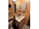 Practical bathroom with peach walls, storage under the sink, and a mirrored cabinet at 35020 Colony Hills Dr, Zephyrhills, FL 33541