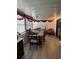 Bright dining room with large windows, hardwood floors, table and chairs at 35020 Colony Hills Dr, Zephyrhills, FL 33541