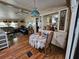 Cozy dining area featuring wood floors, a ceiling fan and an open view to the adjacent living area at 35020 Colony Hills Dr, Zephyrhills, FL 33541