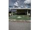 Welcoming single-Gathering home with covered carport, comfortable outdoor furniture, and charming curb appeal at 35020 Colony Hills Dr, Zephyrhills, FL 33541
