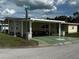 Charming single Gathering home featuring covered carport, attractive curb appeal, and well-manicured landscaping at 35020 Colony Hills Dr, Zephyrhills, FL 33541