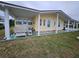 Charming single-story home with carport, well-maintained landscaping and cozy outdoor seating area at 35020 Colony Hills Dr, Zephyrhills, FL 33541