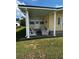 Charming covered front porch featuring comfortable outdoor furniture and creating a welcoming entrance to the home at 35020 Colony Hills Dr, Zephyrhills, FL 33541