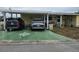 Exterior view featuring a covered driveway with two cars parked and a decorative compass on the concrete at 35020 Colony Hills Dr, Zephyrhills, FL 33541