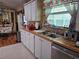 Well-appointed kitchen featuring a stainless steel sink, wood countertops, and ample cabinet space at 35020 Colony Hills Dr, Zephyrhills, FL 33541