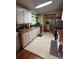 Traditional style kitchen features neutral tile floors, wood counters, and white cabinets at 35020 Colony Hills Dr, Zephyrhills, FL 33541