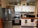 Well-lit kitchen with stainless appliances, wood countertops, and neutral backsplash at 35020 Colony Hills Dr, Zephyrhills, FL 33541