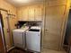 Functional laundry room with cabinetry, washer, and dryer units at 35020 Colony Hills Dr, Zephyrhills, FL 33541