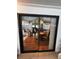 View of living area with hard wood floors through sliding glass doors at 35020 Colony Hills Dr, Zephyrhills, FL 33541