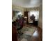 Cozy home office with a colorful rug, desk, and ample storage space at 35020 Colony Hills Dr, Zephyrhills, FL 33541