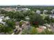 An impressive aerial view features a compact home surrounded by dense foliage and a clearly delineated property outline at 3503 W Palmira Ave, Tampa, FL 33629