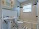 Cozy bathroom with black and white tile flooring, a tiled shower and tub, and an open vanity at 3503 W Palmira Ave, Tampa, FL 33629