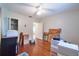Bright bedroom with hardwood floors, a ceiling fan, and closet access at 3503 W Palmira Ave, Tampa, FL 33629