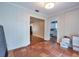 Bedroom with tile floors leading to the kitchen, paneled walls, and modern light fixture at 3503 W Palmira Ave, Tampa, FL 33629