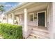 Charming front porch with stone steps and pillars, complemented by manicured landscaping and classic design at 3503 W Palmira Ave, Tampa, FL 33629