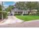 A quaint home with mature trees, a well-maintained lawn, and a long private driveway at 3503 W Palmira Ave, Tampa, FL 33629