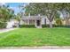 Traditional home featuring a green lawn and manicured shrubs in a peaceful neighborhood setting at 3503 W Palmira Ave, Tampa, FL 33629