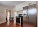 Spacious kitchen boasts stainless steel appliances and hardwood floors, with a view into another room at 3503 W Palmira Ave, Tampa, FL 33629