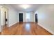 Spacious living room featuring hardwood floors, a front door, and doorways to other rooms at 3503 W Palmira Ave, Tampa, FL 33629