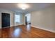Open living room with hardwood flooring, a front door, and large windows at 3503 W Palmira Ave, Tampa, FL 33629