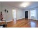 A bright living room featuring gleaming wood floors, a black front door, and ample natural light at 3503 W Palmira Ave, Tampa, FL 33629