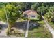 Aerial shot showcasing the property's mature trees, surrounding landscape, and a neatly maintained lawn at 3622 W Mullen Ave, Tampa, FL 33609