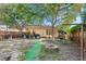 Large backyard with a covered patio, outdoor seating, and a fire pit at 3622 W Mullen Ave, Tampa, FL 33609