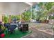 Spacious backyard features a covered patio, ample seating, and mature trees at 3622 W Mullen Ave, Tampa, FL 33609
