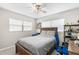 Spacious bedroom with a comfortable bed, natural light, and ceiling fan at 3622 W Mullen Ave, Tampa, FL 33609