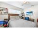 Comfortable bedroom with a bed, desk, TV, and ceiling fan at 3622 W Mullen Ave, Tampa, FL 33609