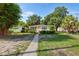 Inviting single-story home with lush greenery, a cozy front porch, and a charming walkway leading to the entrance at 3622 W Mullen Ave, Tampa, FL 33609